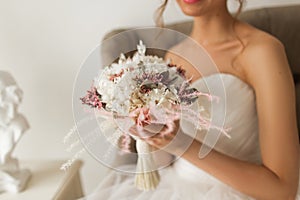 Wedding bouquet in hands of beautiful bride. Wedding concept.