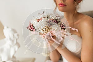 Wedding bouquet in hands of beautiful bride. Wedding concept.