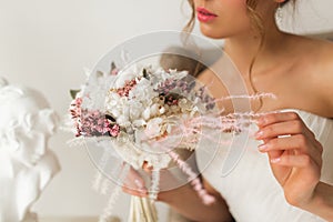 Wedding bouquet in hands of beautiful bride. Wedding concept.