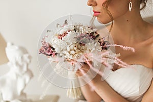 Wedding bouquet in hands of beautiful bride. Wedding concept.