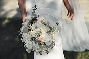 Wedding bouquet in hands of bride