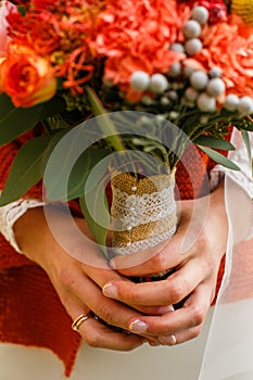 wedding bouquet in the hands of the bride