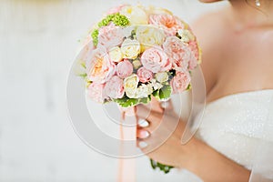 Wedding bouquet in hands of the bride.