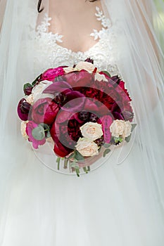 Wedding bouquet in the hands of the bride