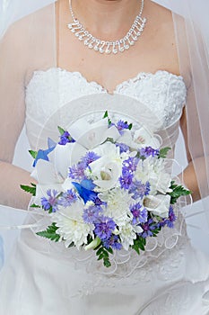 Wedding bouquet in hands of the bride