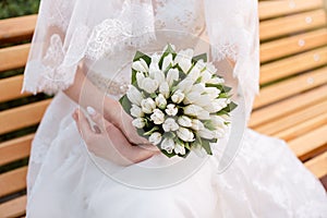 Wedding bouquet in hands of the bride