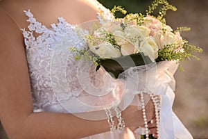 Wedding bouquet in hands of the bride