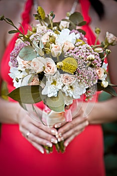 Wedding bouquet in hands of bride.