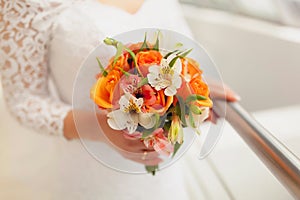 Wedding bouquet in the hands of the bride