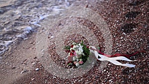 Wedding bouquet in hands of the bride on the beach Milocer Park