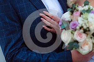 Wedding bouquet in the hands of the bride at the ceremony.