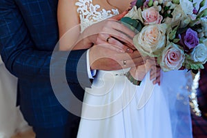 Wedding bouquet in the hands of the bride at the ceremony.