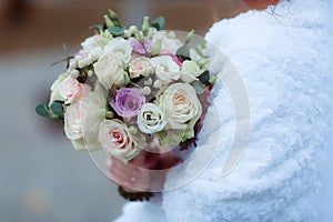 Wedding bouquet in the hands of the bride at the ceremony.