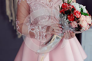 Wedding bouquet in the hands of the bride at the ceremony.