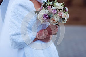 Wedding bouquet in the hands of the bride at the ceremony.