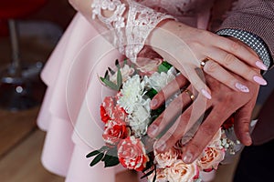 Wedding bouquet in the hands of the bride at the ceremony.