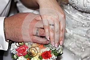 Wedding bouquet in the hands of the bride and groom