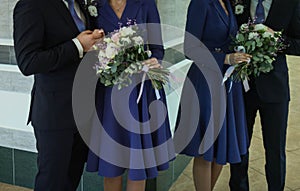 Wedding bouquet in hands of bride and groom and reflection in mirrow, selective focus