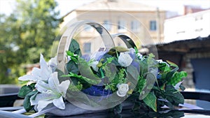 Wedding bouquet lies on the car. Beautiful bouquet by car . Wedding day. Summer Day. Flowers