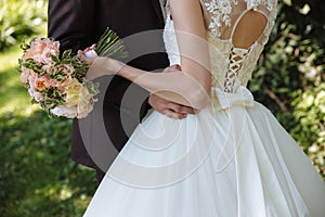 Wedding bouquet in marriage couple hands