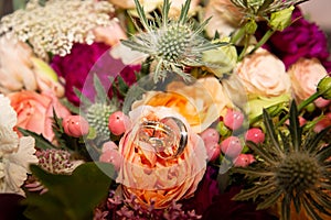 Wedding bouquet and marriage rings close up