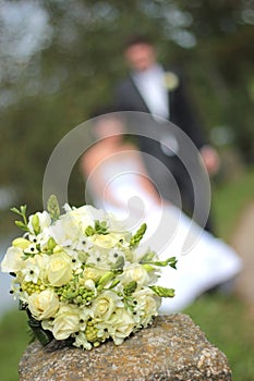 Wedding bouquet and newly married couple