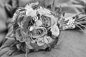 Wedding bouquet on an orange pillow, bouquet of bride from rose cream spray, rose bush, rose purple Memory Lane, violet eustoma,