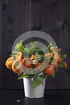 Wedding bouquet with orange Ranunculus and Ornithogalum Dubium on the wooden background