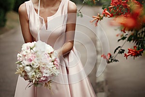 Wedding bouquet of pink roses and white flowers. bride holding i