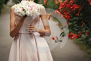 Wedding bouquet of pink roses and white flowers. bride holding i