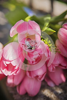 wedding bouquet with pink tulips and golden rings