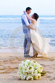 Wedding bouquet put on the beach.