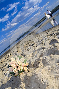 Wedding bouquet of roses on the beach