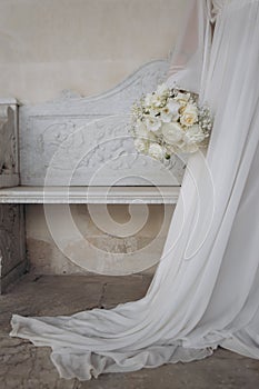 Wedding bouquet of roses and fresias in a castle of white marble.