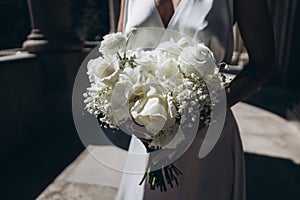 Wedding bouquet of roses and fresias in a castle of white marble.