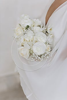 Wedding bouquet of roses and fresias in a castle of white marble.