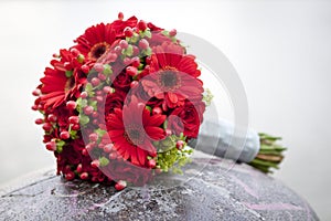 Wedding bouquet with roses and herbera photo