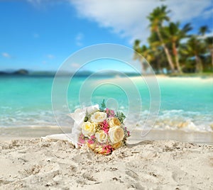 Wedding bouquet of roses on the shore of a tropical beach in the