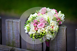 Wedding bouquet on rustic country fence