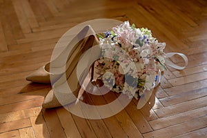 Wedding bouquet and shoes of the bride