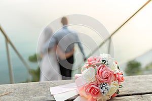 Wedding bouquet on wedding couple background, stay at the beach