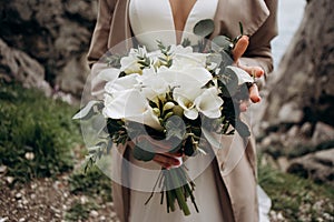 Wedding bouquet of white callas. Wedding floristry.