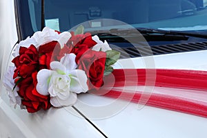 Wedding bouquet on a white car hood
