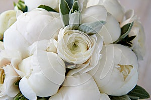 Wedding bouquet of white peonies and ranunculuses. Wedding floristry photo
