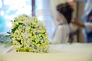 Wedding bouquet with wife in backgound