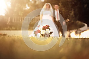 Wedding bouquete laying on the grass photo