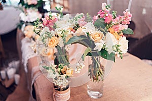 Wedding bouquets of yellow roses in vases.