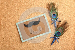 Wedding boutonnieres with peacock feather and card