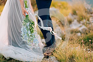 Wedding bridal bouquet of blue Delphinium in the hands of the br