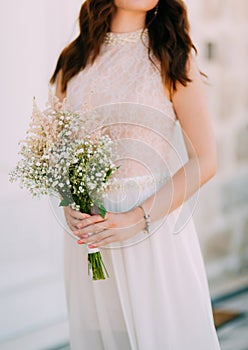 Wedding bridal bouquet of Gypsophila in the hands of the bride.